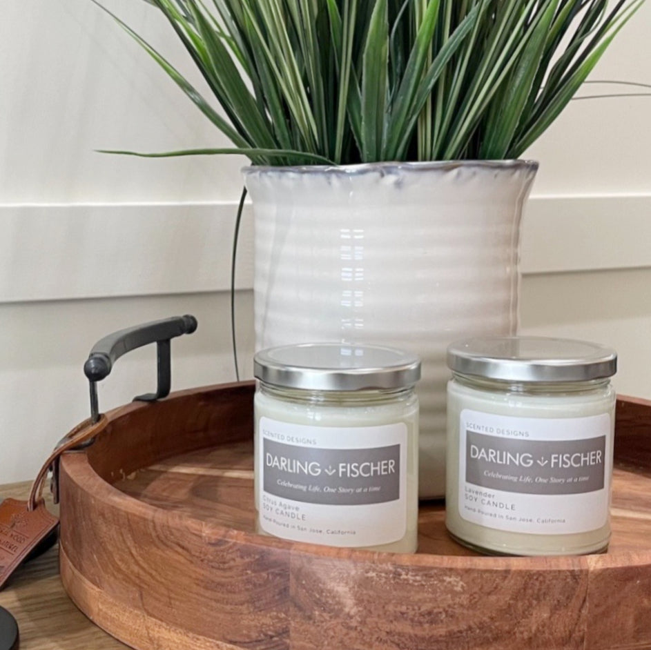 hand poured soy candles on wooden tray with plant 